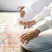 Muslim men praying in Tashahhud posture